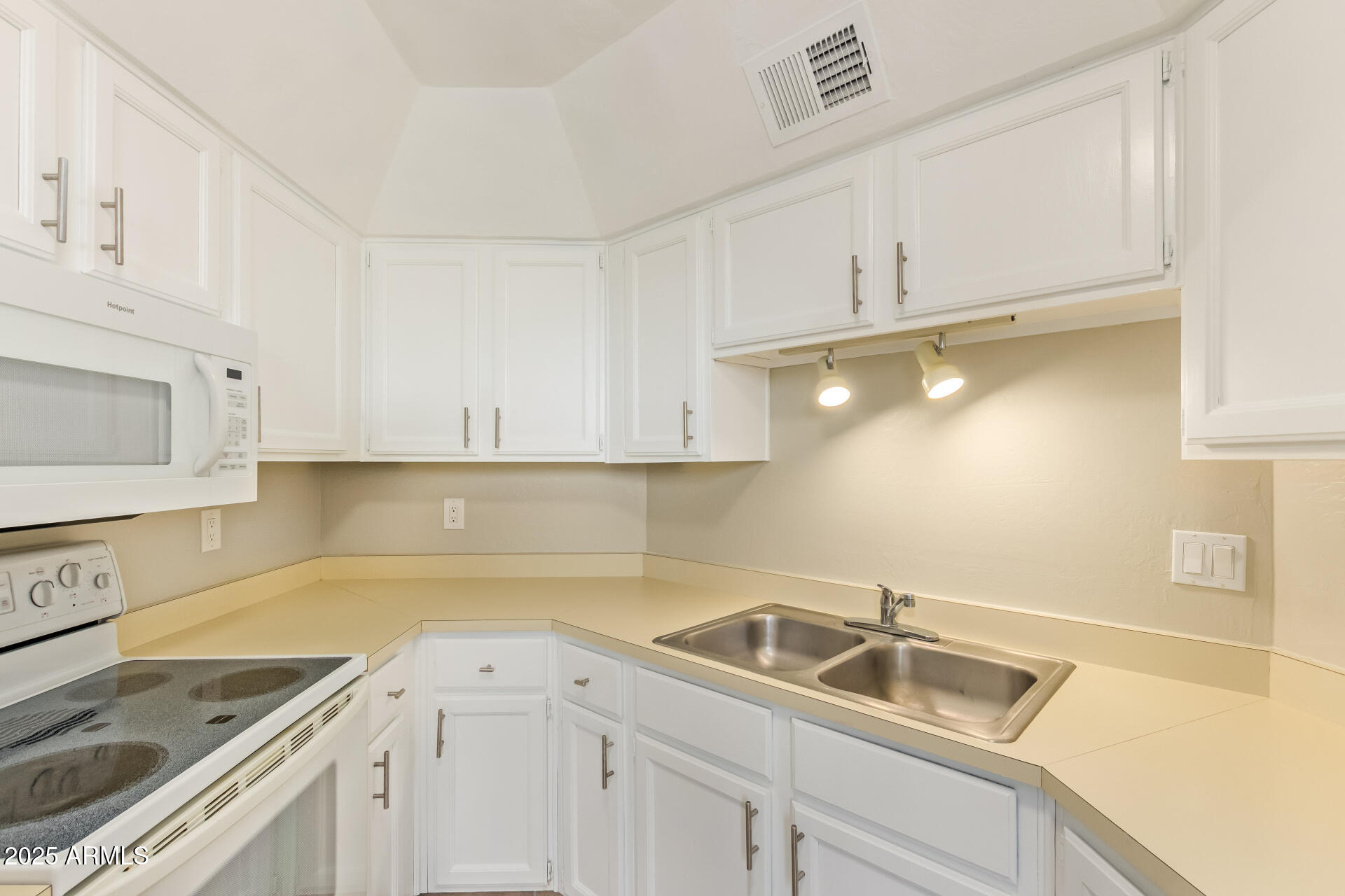 4328 North 36th Street, Unit 3 Phoenix, AZ 85018 - Photo 13 of 15 a kitchen with white cabinets sink and stove