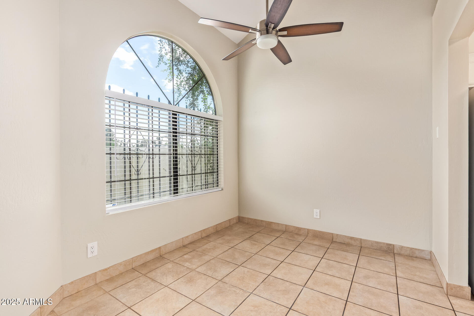 4328 North 36th Street, Unit 3 Phoenix, AZ 85018 - Photo 5 of 15 an empty room with windows and fan
