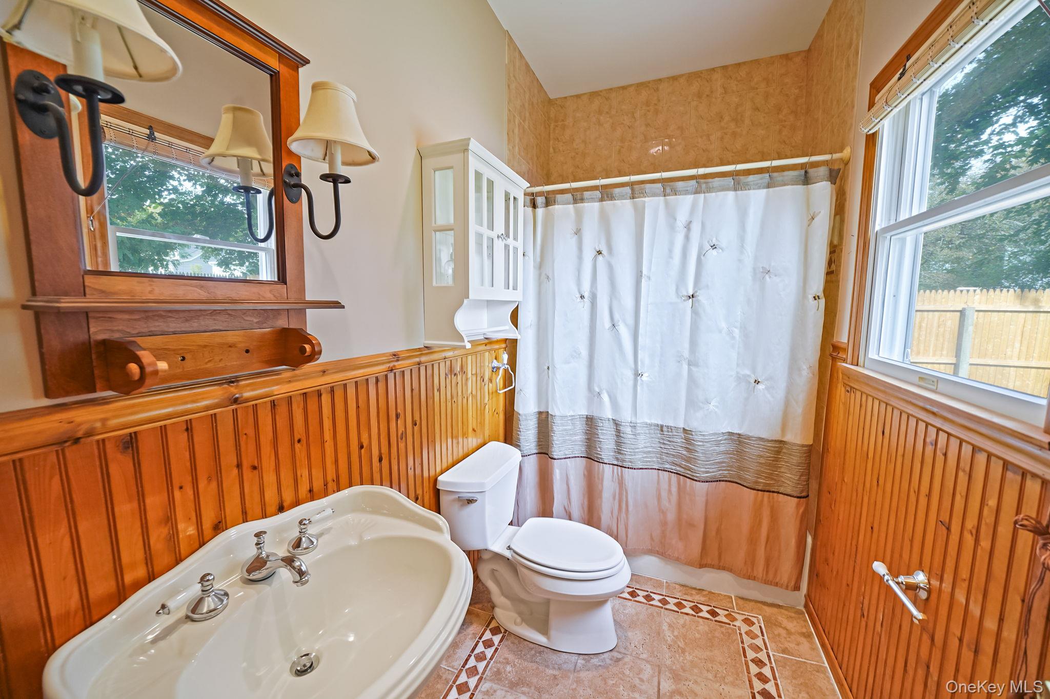 26 Bokel Road Ronkonkoma, NY 11779 - Photo 12 of 34 a bathroom with a sink toilet and shower
