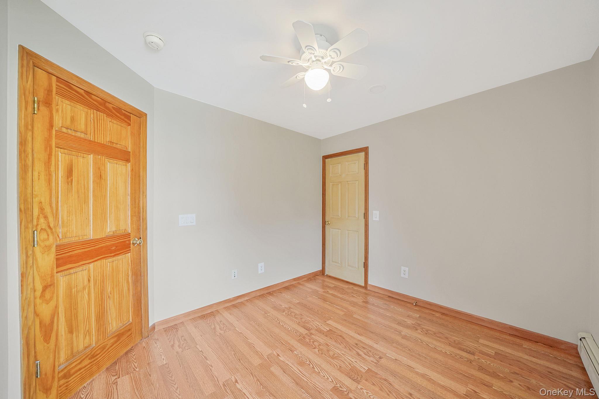 26 Bokel Road Ronkonkoma, NY 11779 - Photo 14 of 34 a view of an empty room with wooden floor