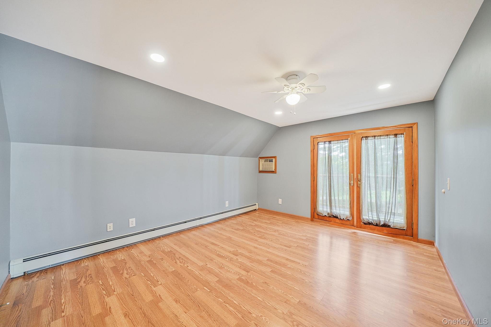 26 Bokel Road Ronkonkoma, NY 11779 - Photo 17 of 34 wooden floor in an empty room with a window