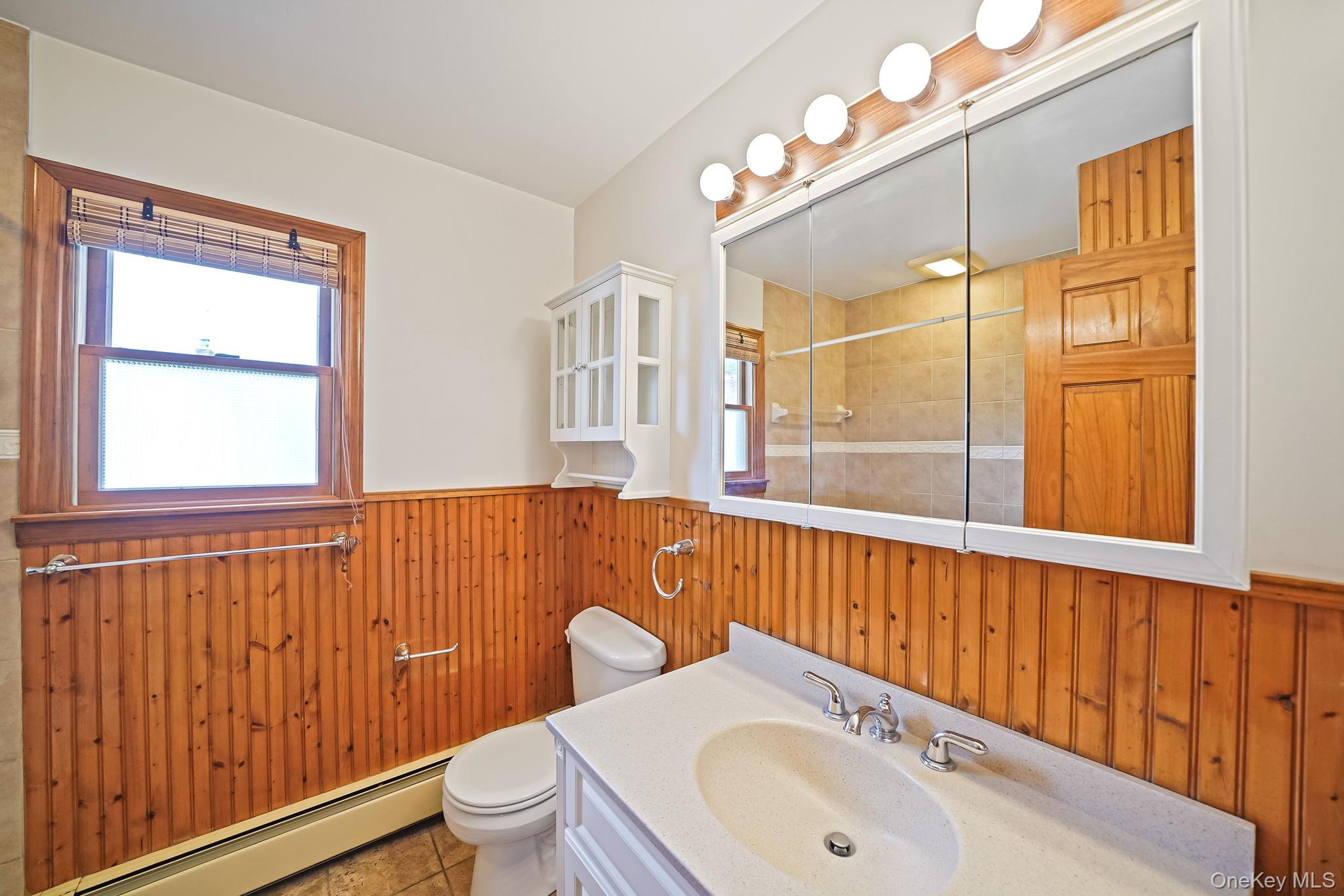 26 Bokel Road Ronkonkoma, NY 11779 - Photo 19 of 34 a bathroom with a sink a mirror and a toilet