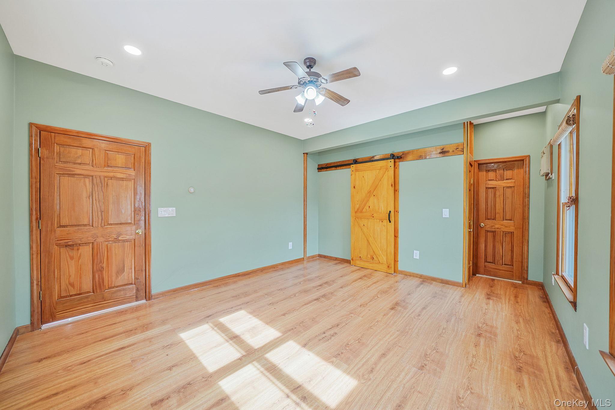 26 Bokel Road Ronkonkoma, NY 11779 - Photo 10 of 34 a view of an empty room window and wooden floor