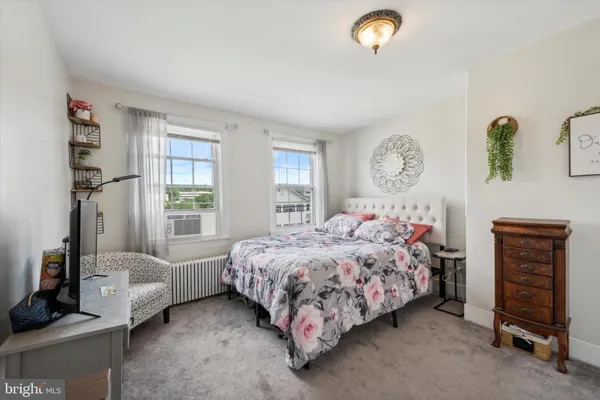 a bed sitting in a bedroom next to a window