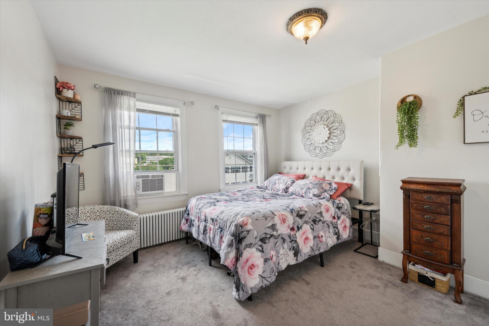 20 South Village Avenue, Unit 1 Exton, PA 19341 - Photo 6 of 13 a bed sitting in a bedroom next to a window