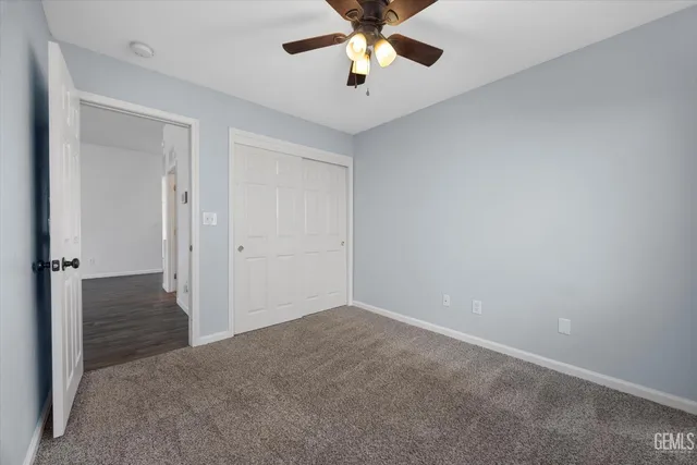 a view of empty room with wooden floor and fireplace