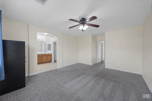 a spacious bathroom with a tub sink and a mirror