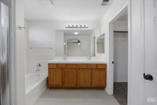 a bathroom with a double vanity sink and a mirror