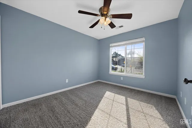 a view of a livingroom with a ceiling fan and window