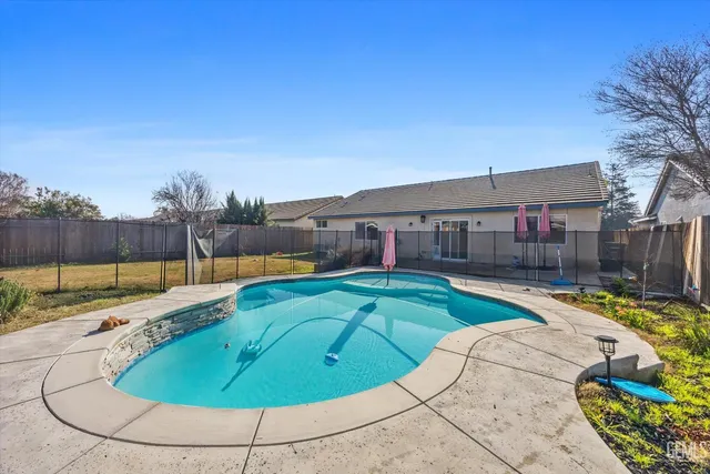 a backyard of a house with table and chairs