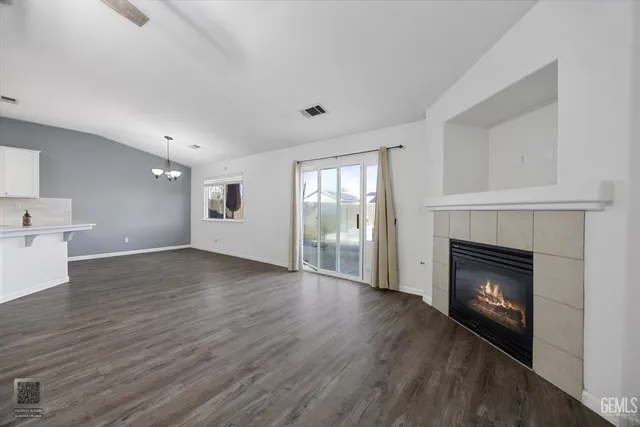 a view of a room with window wooden floor and chandelier