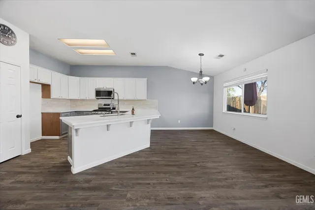 a kitchen with a sink appliances and cabinets