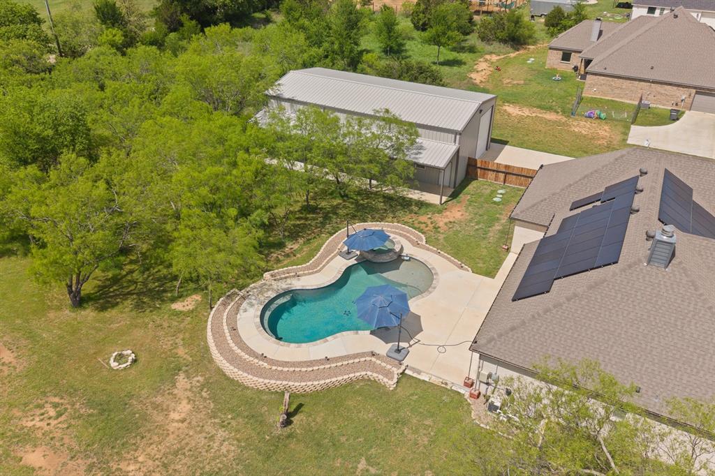 1001 Resolute Road Millsap, TX 76066 - Photo 32 of 40 a view of a swimming pool in a backyard