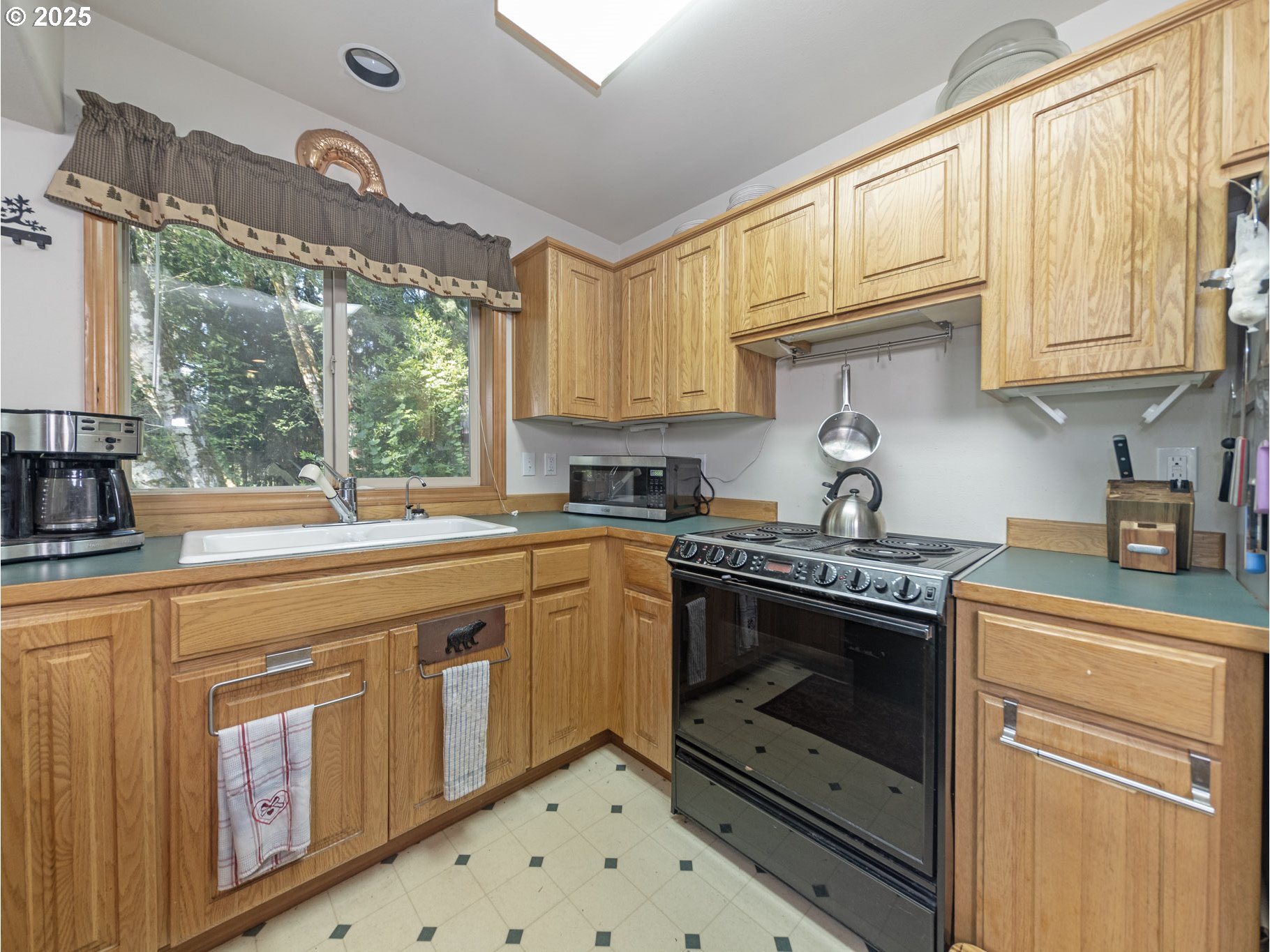 71397 Fishhawk Road Clatskanie, OR 97016 - Photo 12 of 48 a kitchen with stainless steel appliances granite countertop a stove a sink and a white cabinets