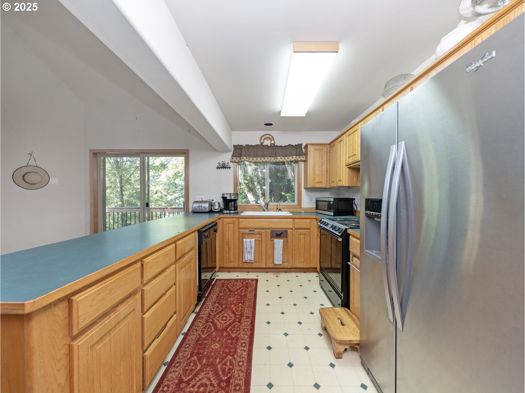 71397 Fishhawk Road Clatskanie, OR 97016 - Photo 13 of 48 a kitchen with granite countertop a refrigerator and a sink