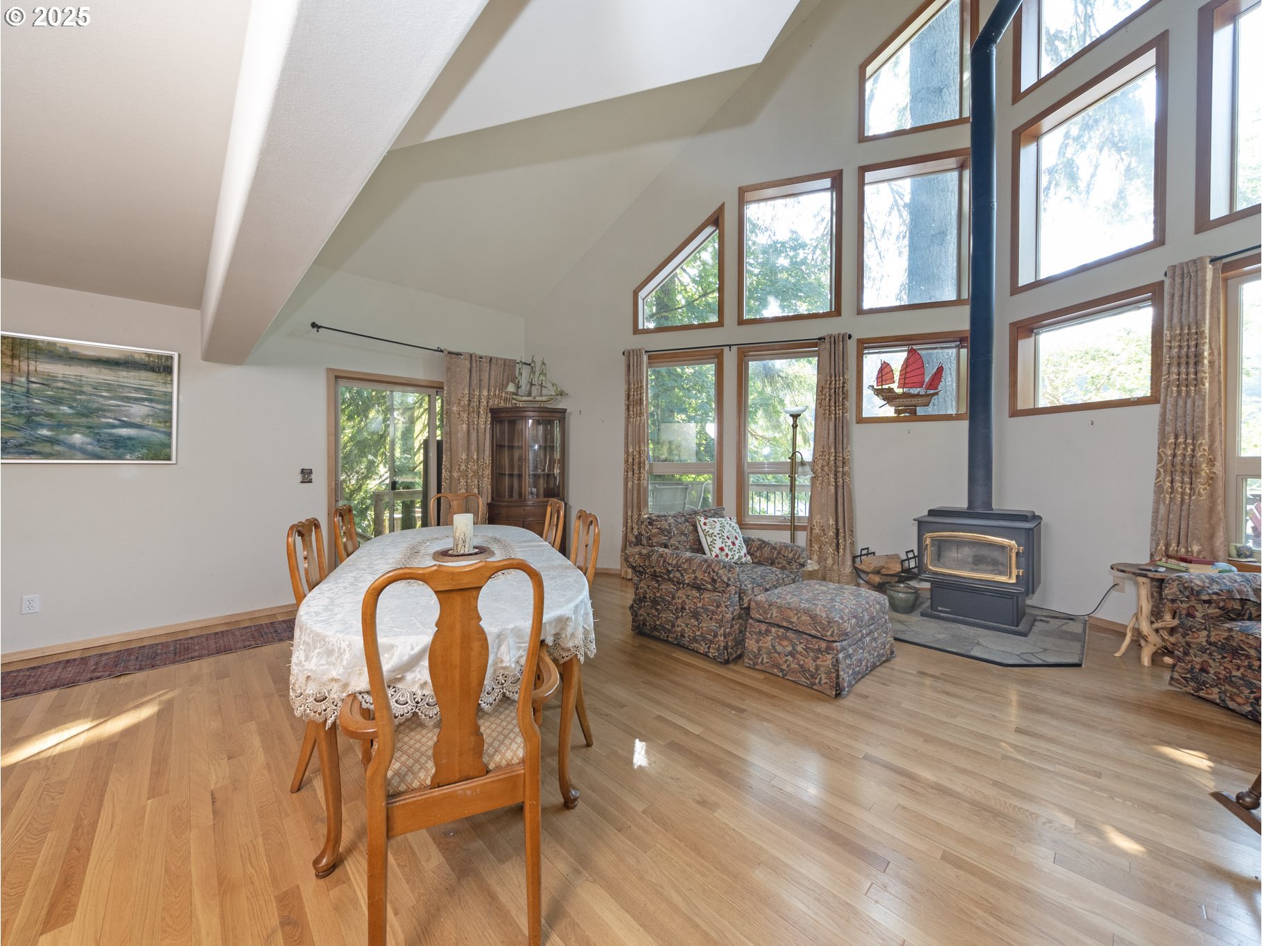 71397 Fishhawk Road Clatskanie, OR 97016 - Photo 15 of 48 a living room with furniture a fireplace and large windows