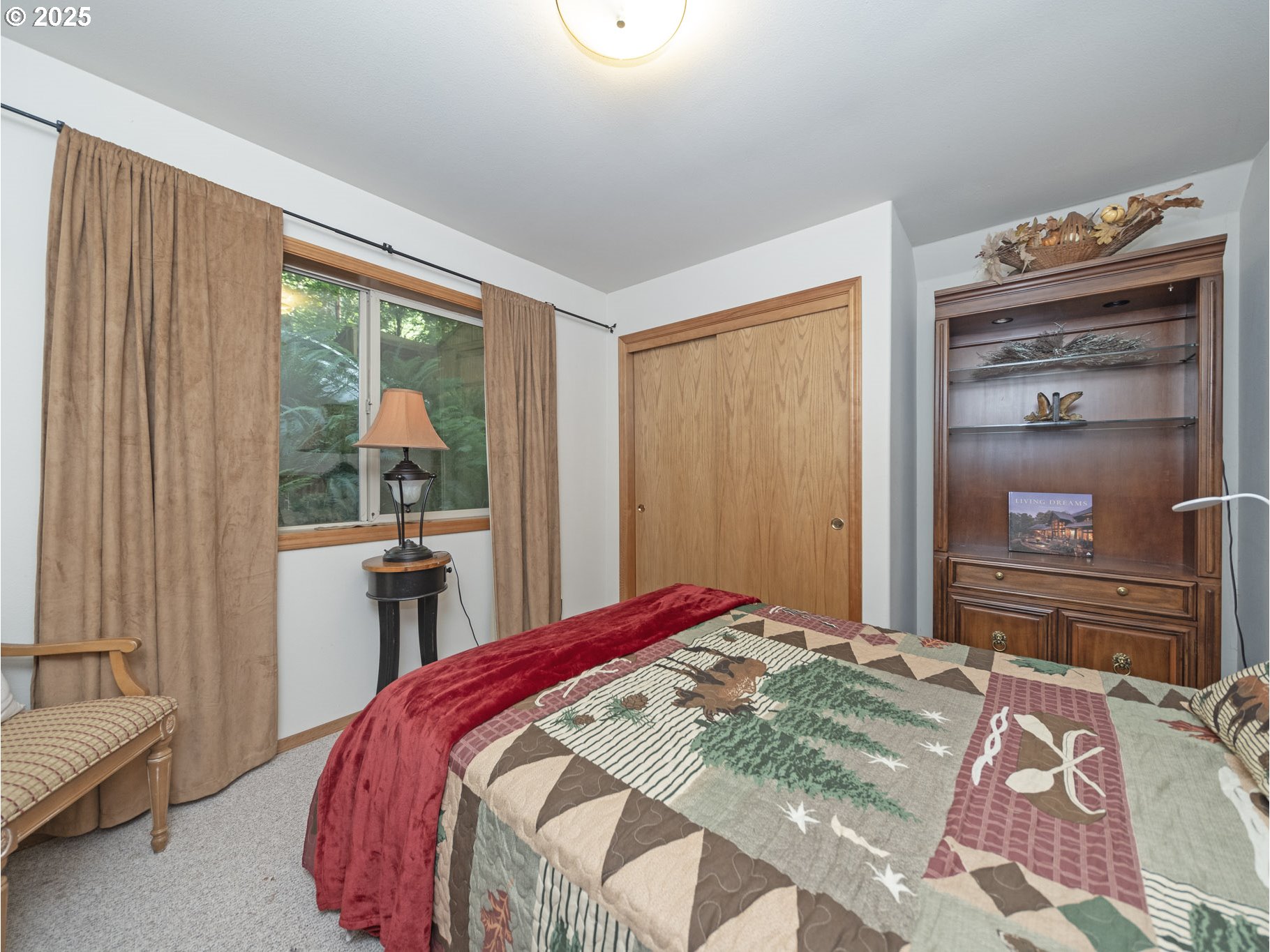 71397 Fishhawk Road Clatskanie, OR 97016 - Photo 20 of 48 a bedroom with a bed and a dresser with mirror