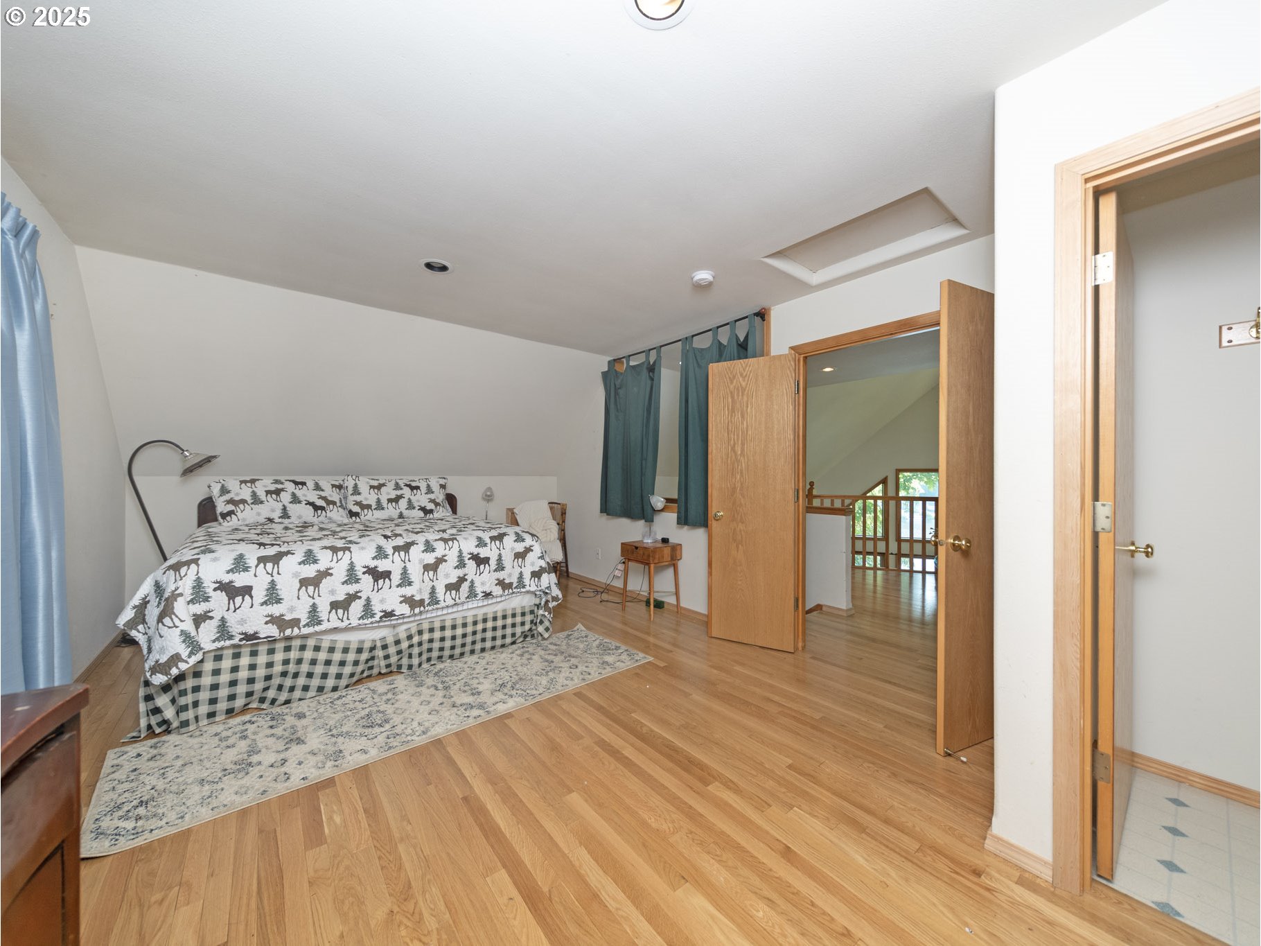 71397 Fishhawk Road Clatskanie, OR 97016 - Photo 28 of 48 a bedroom with a bed and a table with wooden floor