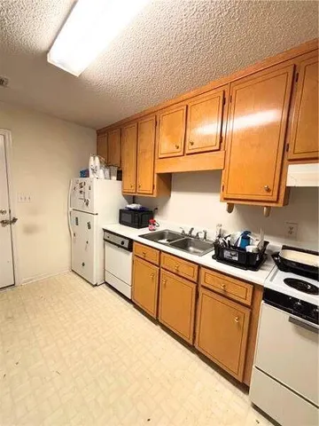 a kitchen with stainless steel appliances a sink stove and cabinets