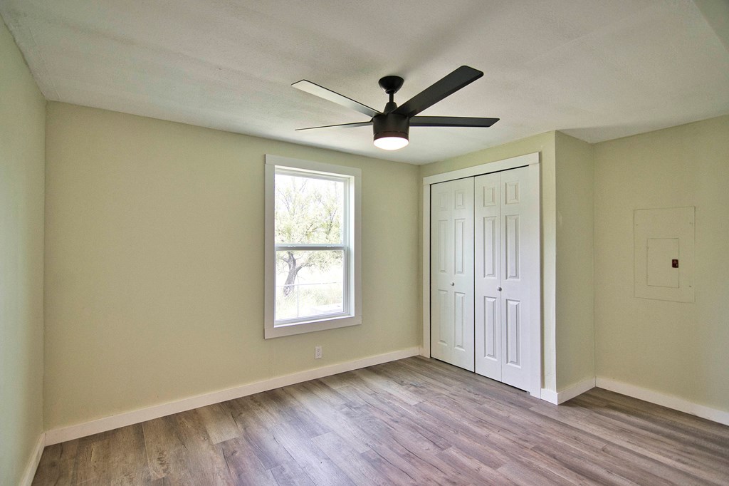 425 Post Hill Street Mason, TX 76856 - Photo 13 of 21 a view of empty room with wooden floor and fan