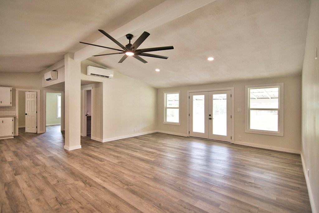 425 Post Hill Street Mason, TX 76856 - Photo 3 of 21 a view of an empty room with window and wooden floor