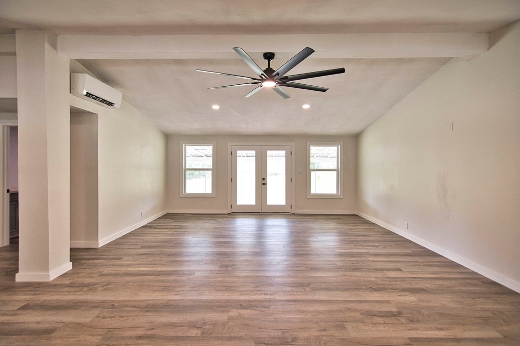 425 Post Hill Street Mason, TX 76856 - Photo 6 of 21 a view of an empty room with window and wooden floor