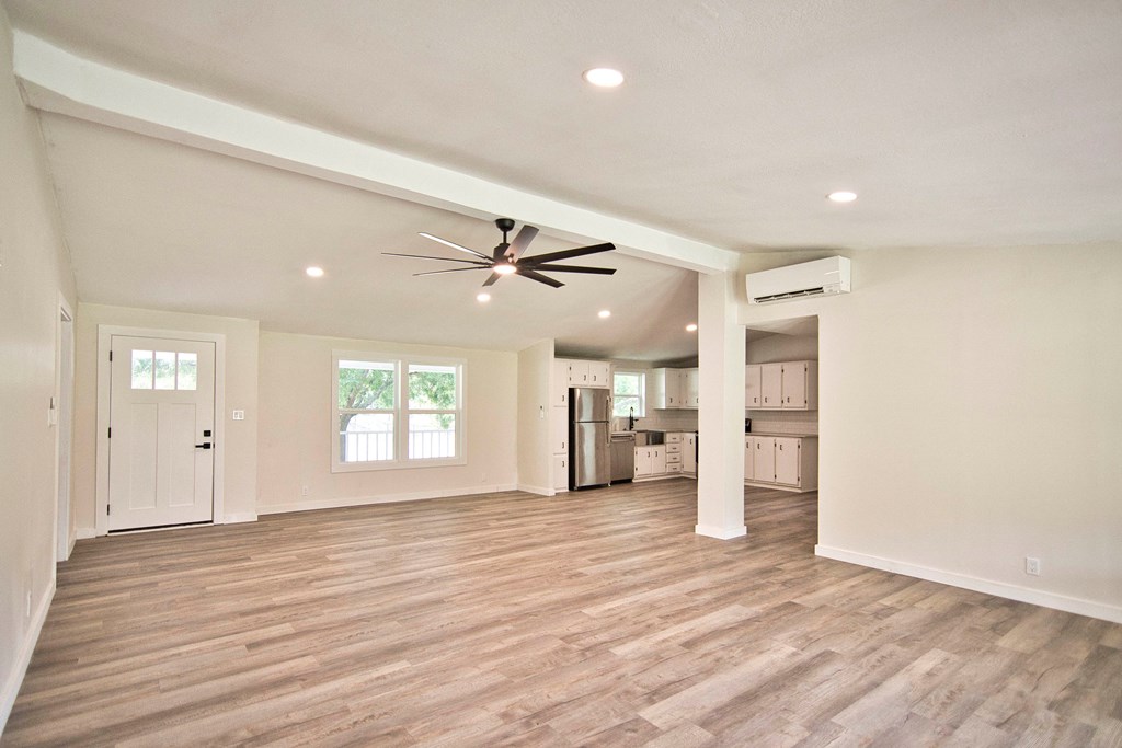 425 Post Hill Street Mason, TX 76856 - Photo 7 of 21 a view of a livingroom with a ceiling fan window and wooden floor