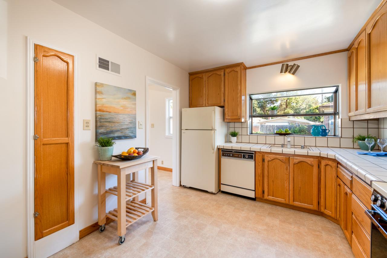 8 Oak Court Sunnyvale, CA 94086 - Photo 11 of 30 a kitchen with a refrigerator and white cabinets