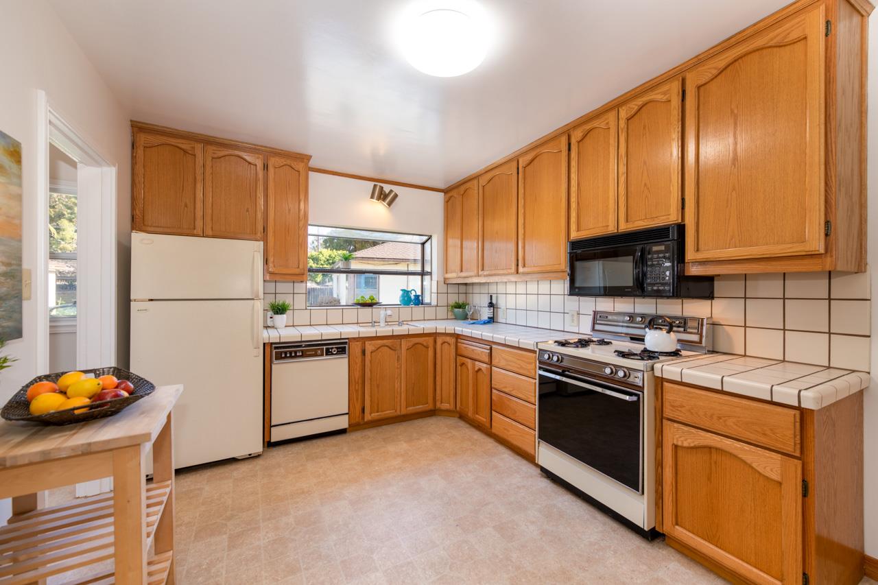8 Oak Court Sunnyvale, CA 94086 - Photo 10 of 30 a kitchen with stainless steel appliances granite countertop a refrigerator sink stove microwave and cabinets
