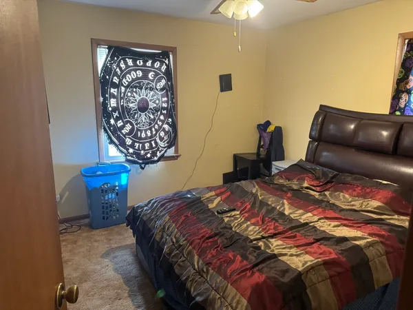 a bedroom with a bed and a lamp on table