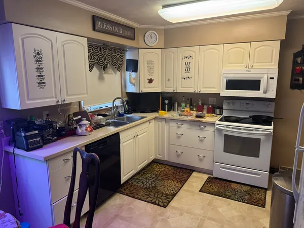a kitchen with a sink stove and microwave