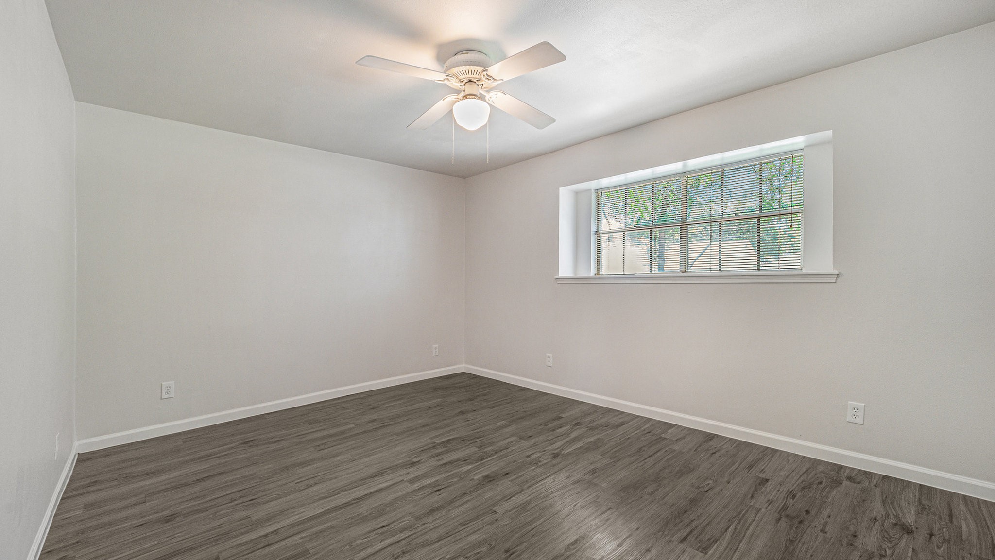 1003 Pear Tree Lane Houston, TX 77073 - Photo 14 of 15 an empty room with wooden floor and windows