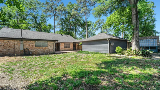 a front view of a house with a yard and trees
