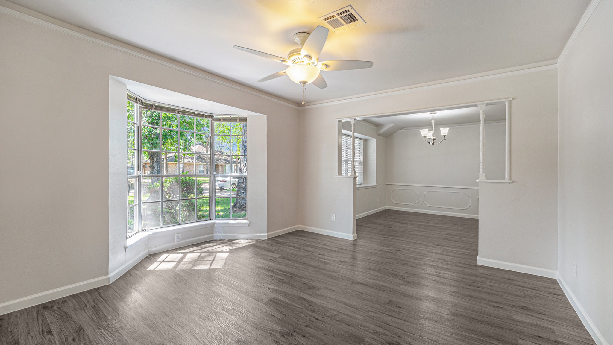 1003 Pear Tree Lane Houston, TX 77073 - Photo 4 of 15 a view of an empty room with wooden floor and a window