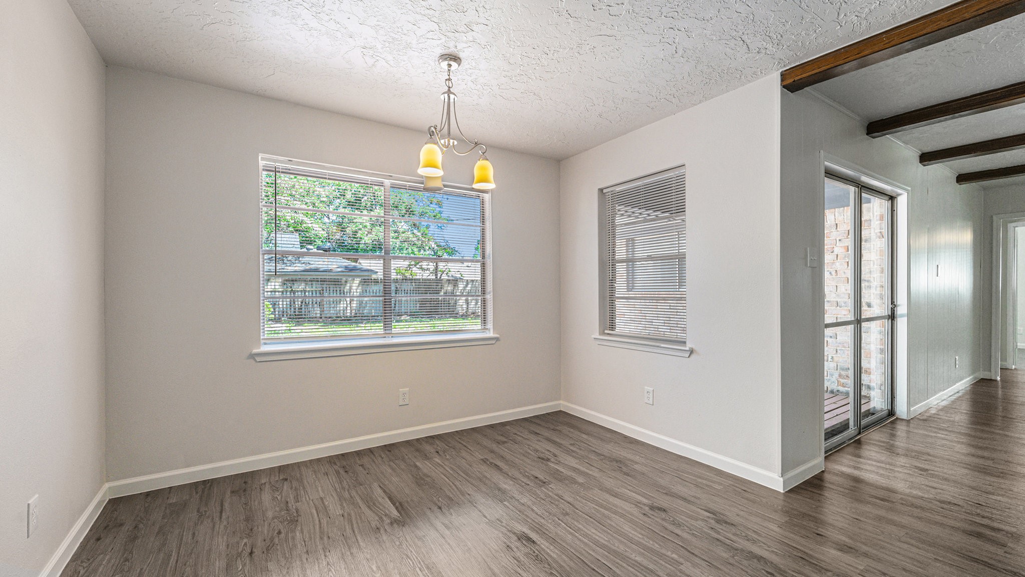 1003 Pear Tree Lane Houston, TX 77073 - Photo 5 of 15 a view of an empty room with wooden floor fridge and a window