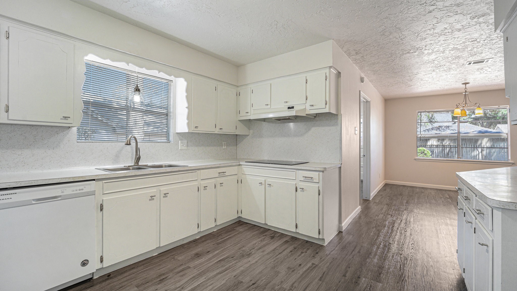 1003 Pear Tree Lane Houston, TX 77073 - Photo 7 of 15 a kitchen with sink cabinets and wooden floor