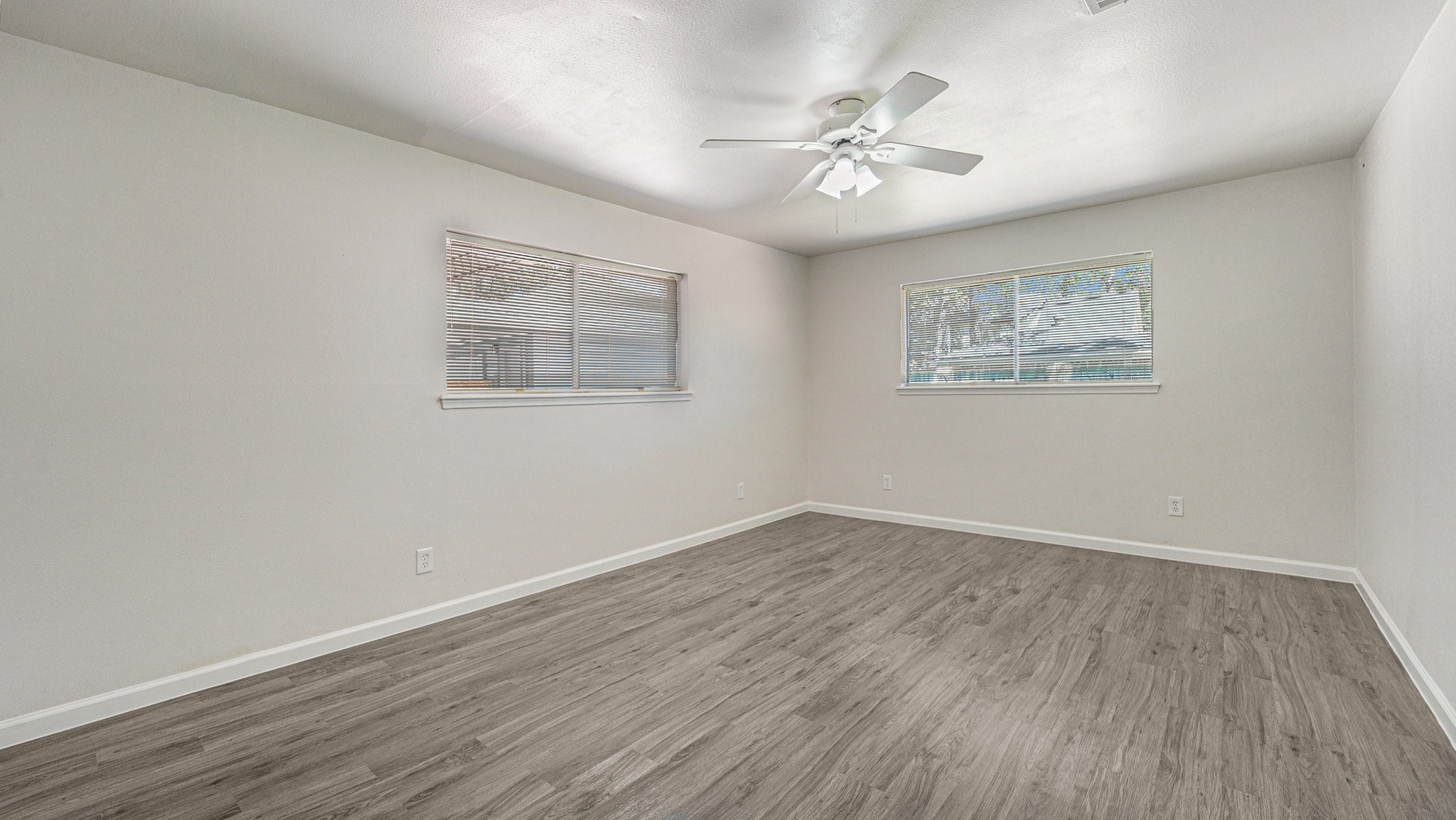 1003 Pear Tree Lane Houston, TX 77073 - Photo 8 of 15 a view of an empty room with wooden floor and a chandelier fan