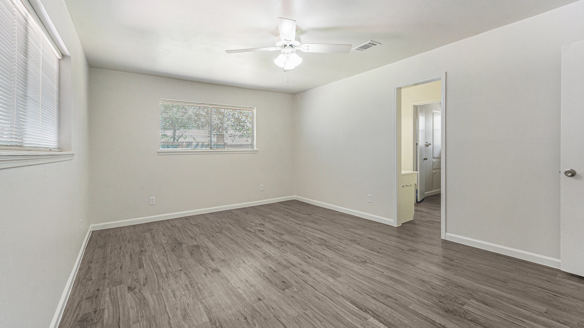 1003 Pear Tree Lane Houston, TX 77073 - Photo 9 of 15 wooden floor in an empty room with a window