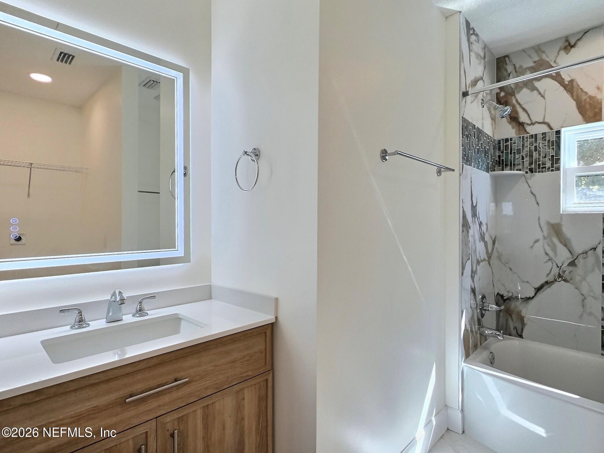 159 Mays Cove Road East Palatka, FL 32131 - Photo 49 of 62 a bathroom with a granite countertop sink toilet and shower