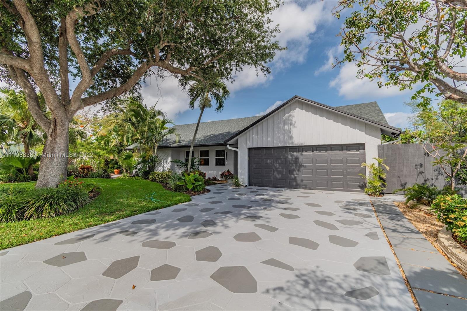 3015 Dunlin Road Delray Beach, FL 33444 - Photo 1 of 47 a front view of a house with a garden