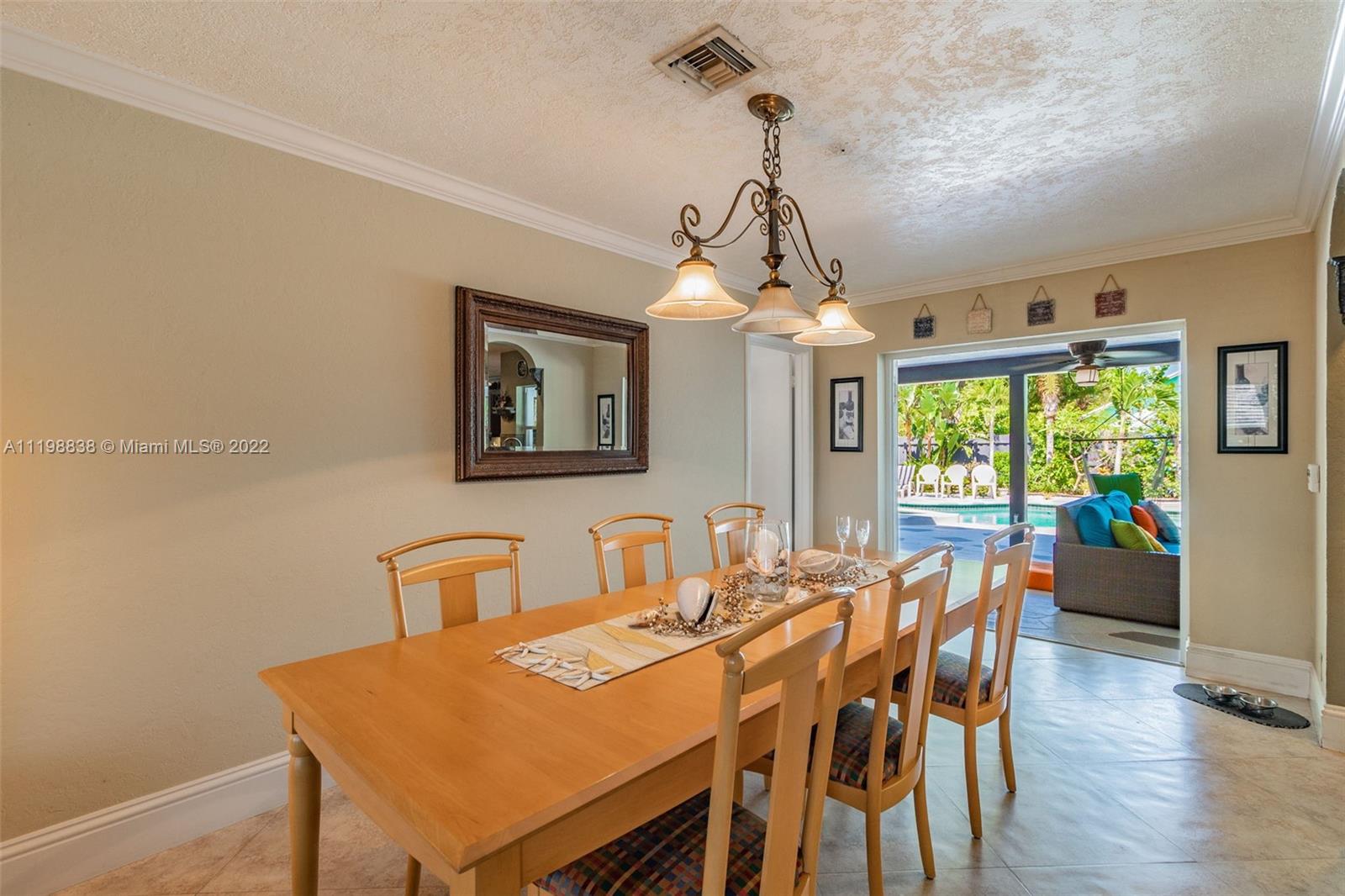 3015 Dunlin Road Delray Beach, FL 33444 - Photo 14 of 47 a view of a dining room with furniture window and wooden floor