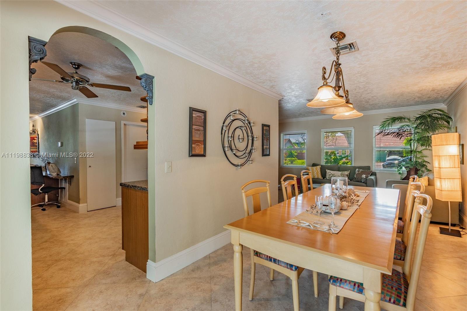 3015 Dunlin Road Delray Beach, FL 33444 - Photo 15 of 47 a view of a dining room with furniture window and wooden floor