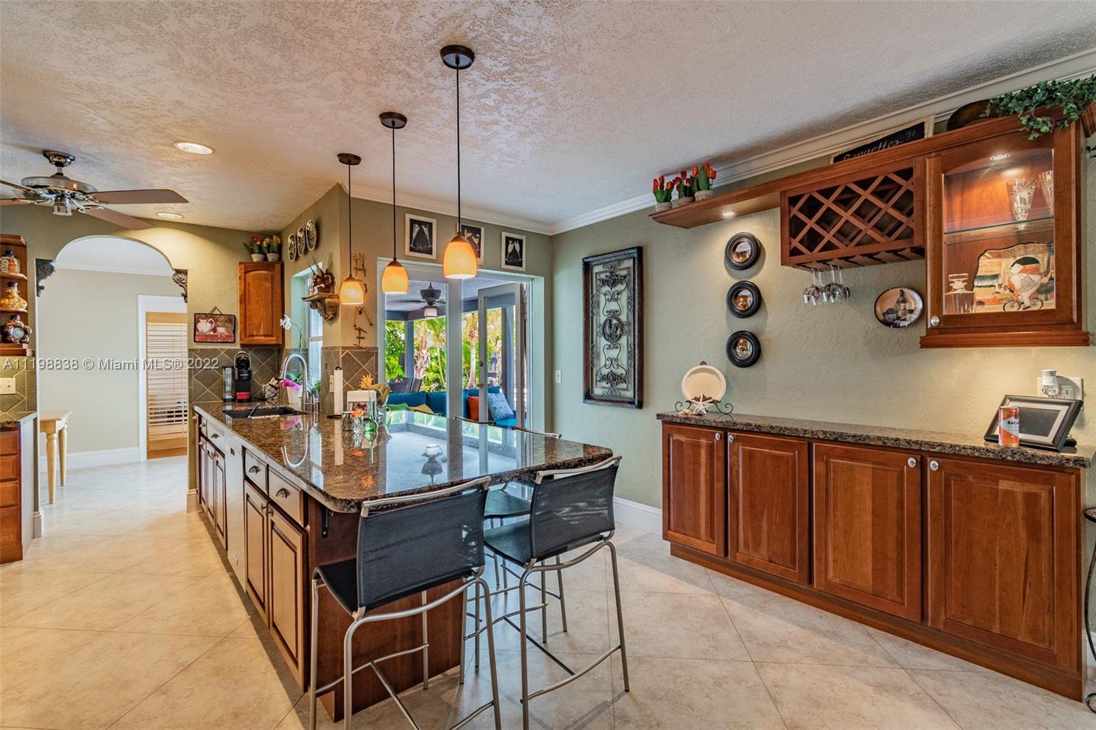 3015 Dunlin Road Delray Beach, FL 33444 - Photo 19 of 47 a kitchen with stainless steel appliances granite countertop a stove a sink dishwasher and cabinets with wooden floor
