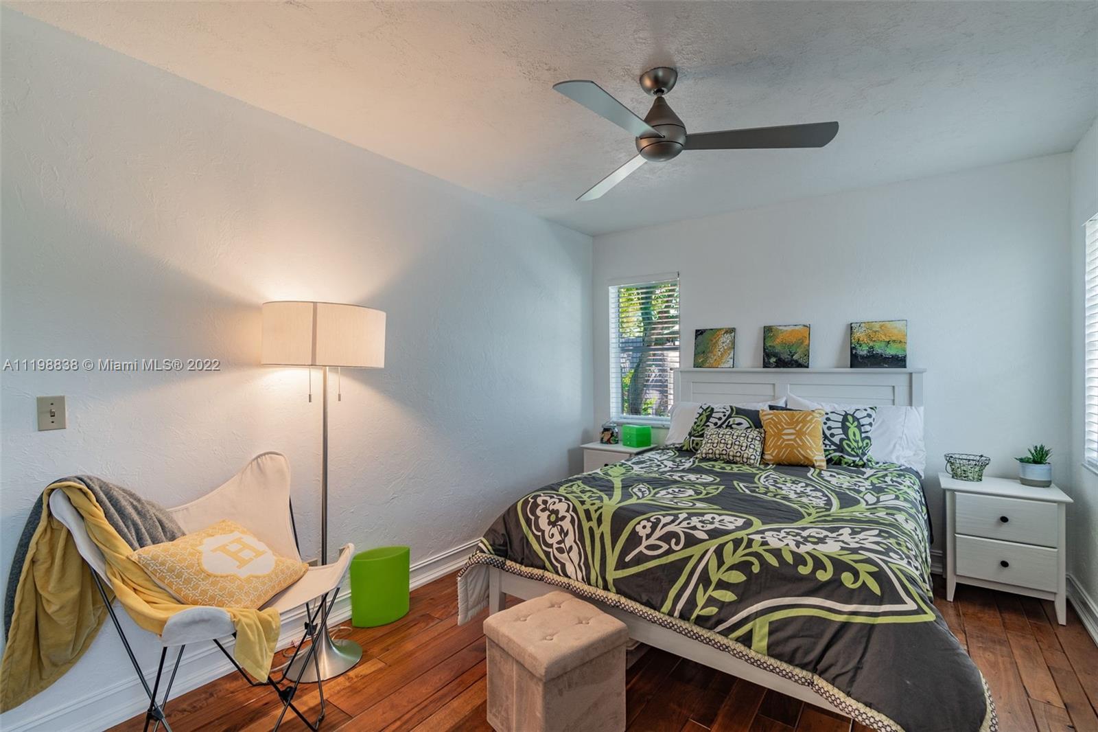 3015 Dunlin Road Delray Beach, FL 33444 - Photo 23 of 47 a bedroom with a bed and a chandelier
