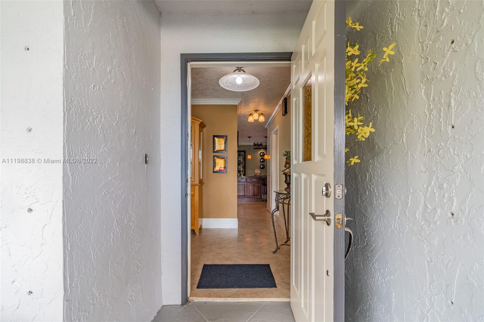 3015 Dunlin Road Delray Beach, FL 33444 - Photo 3 of 47 a view of a hallway with wooden floor