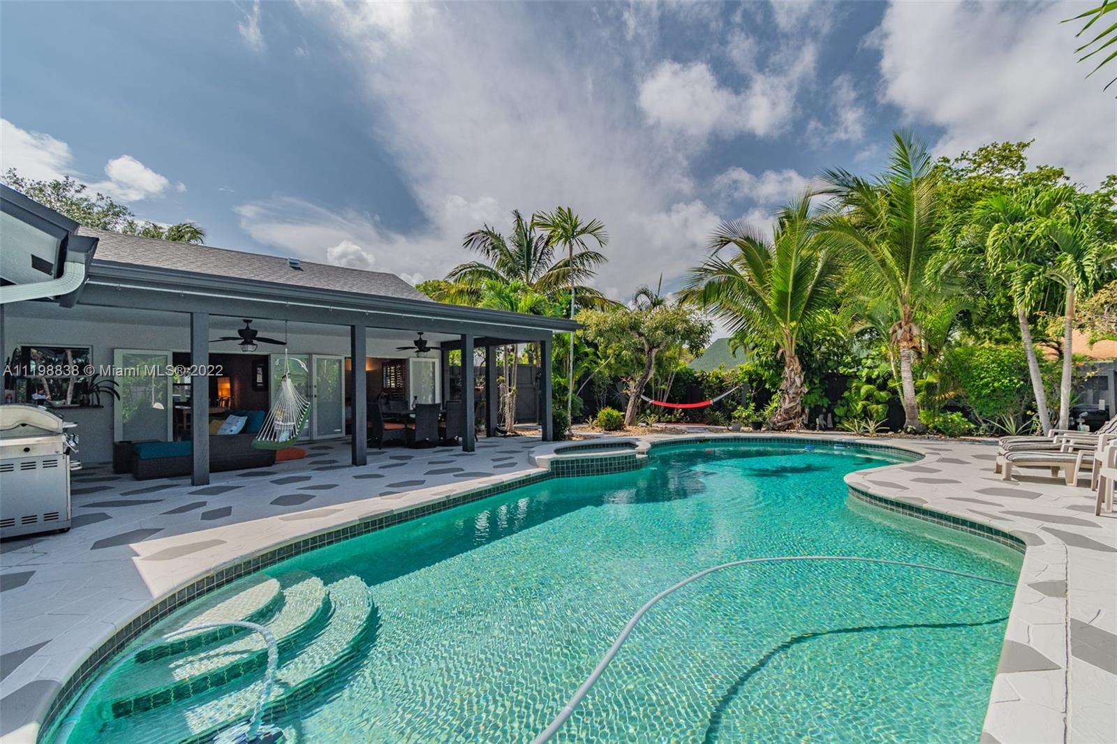 3015 Dunlin Road Delray Beach, FL 33444 - Photo 32 of 47 a view of a house with swimming pool and sitting area