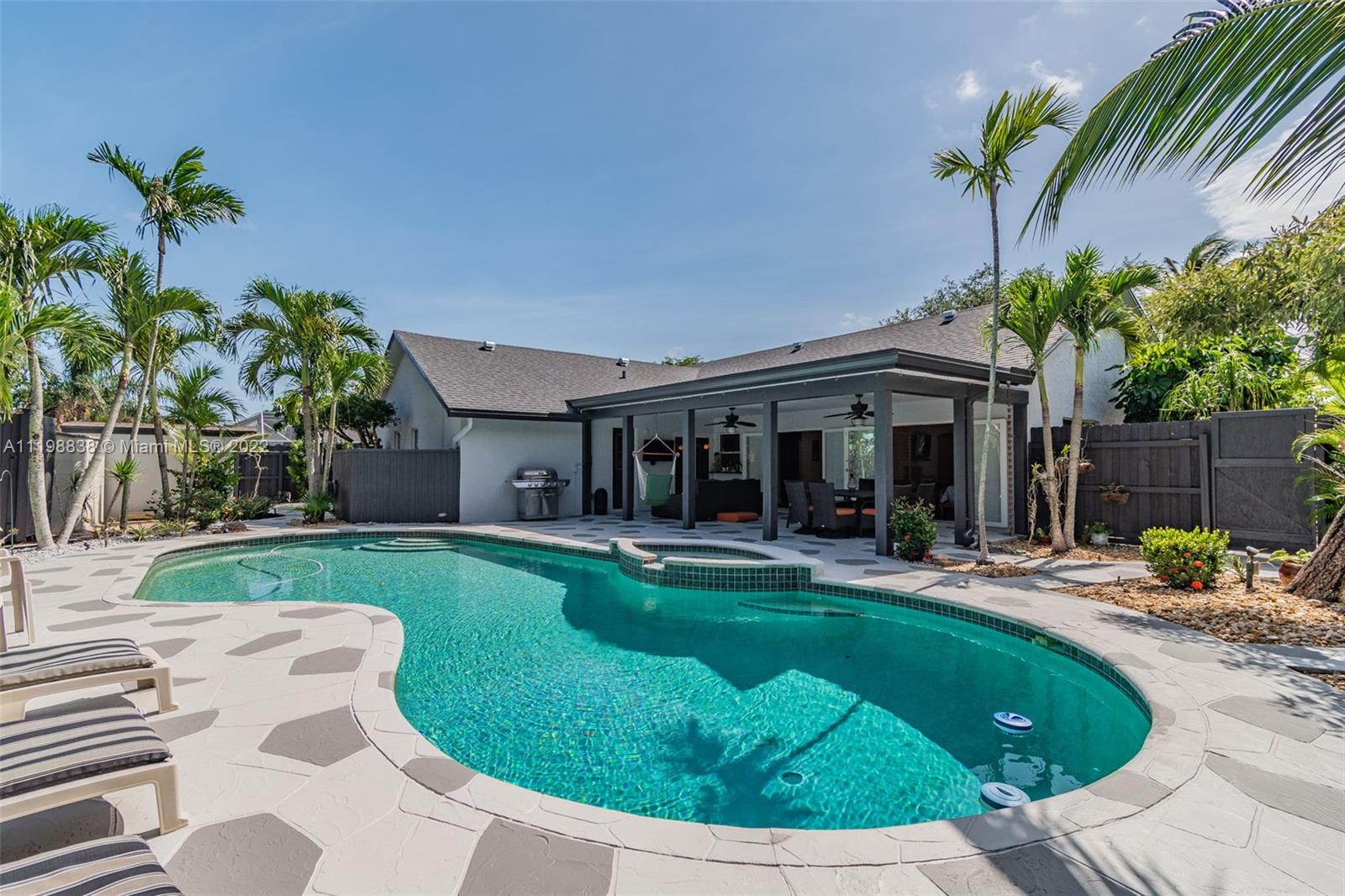 3015 Dunlin Road Delray Beach, FL 33444 - Photo 33 of 47 a view of a house with a yard porch and sitting area