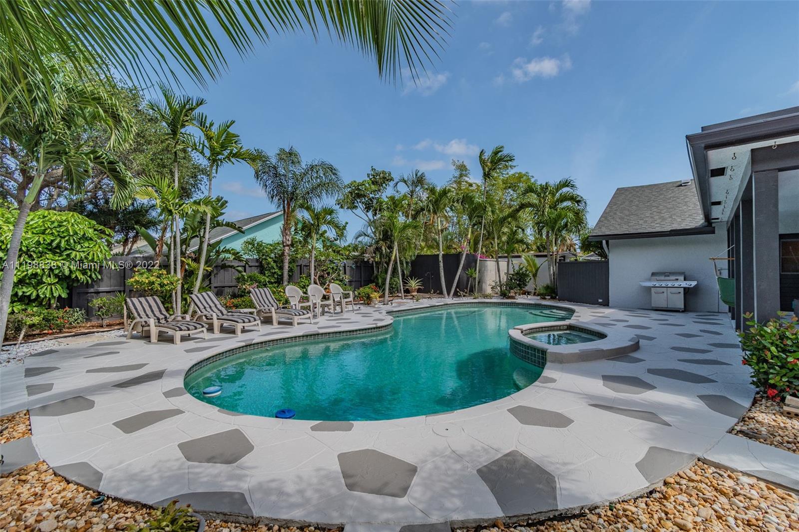 3015 Dunlin Road Delray Beach, FL 33444 - Photo 34 of 47 a view of a swimming pool with a patio