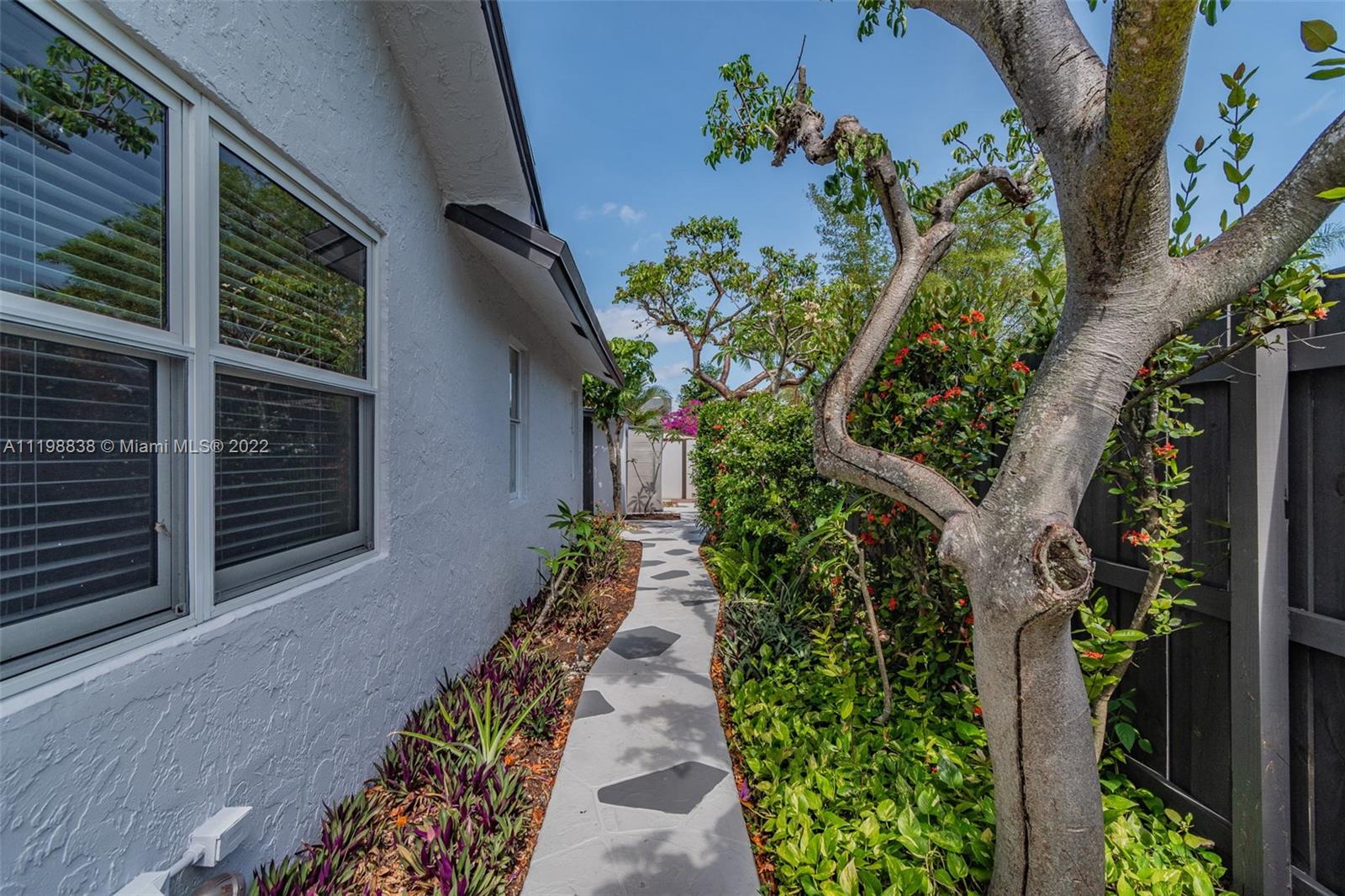 3015 Dunlin Road Delray Beach, FL 33444 - Photo 35 of 47 a view of a pathway with flower plants