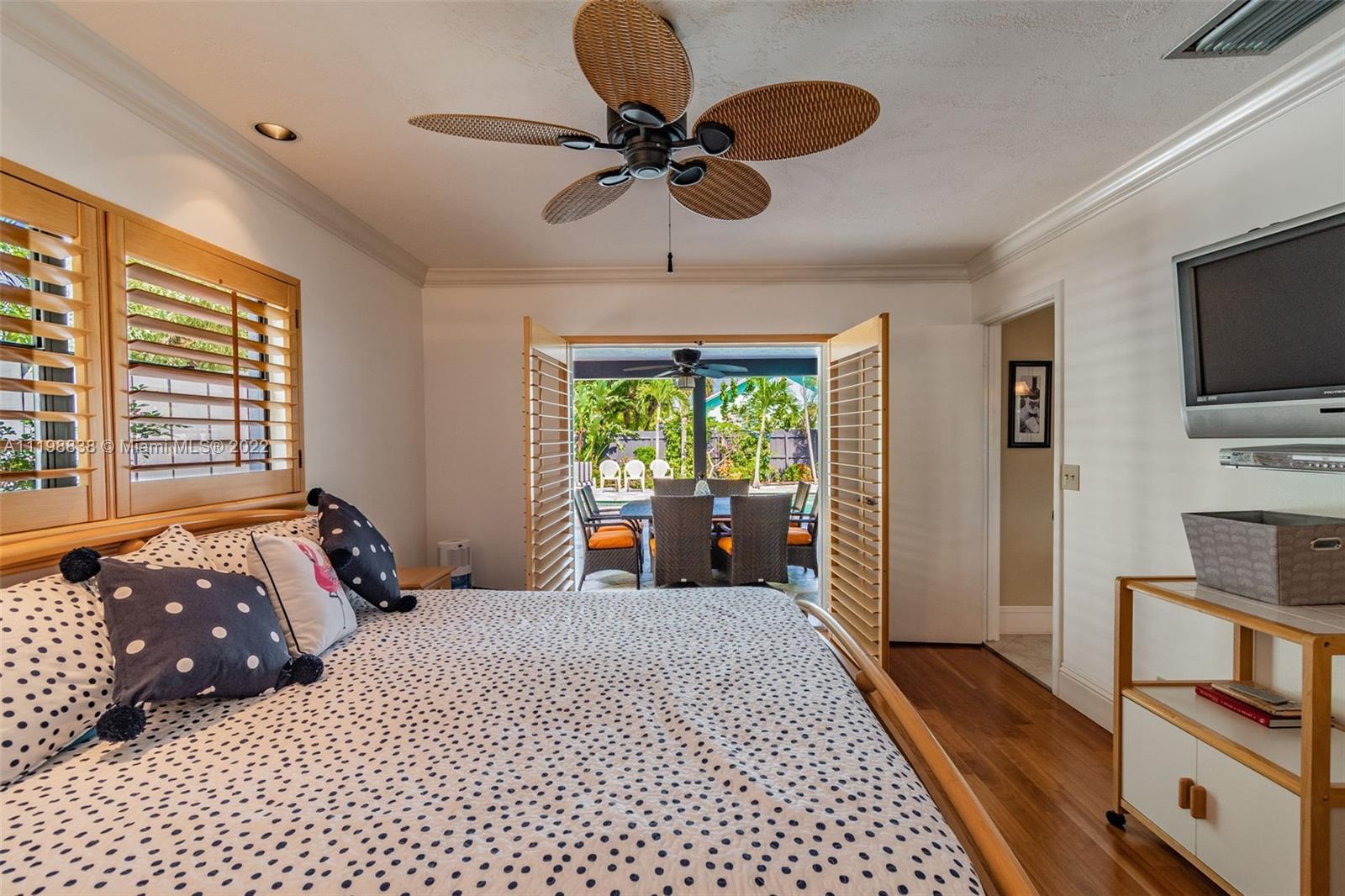 3015 Dunlin Road Delray Beach, FL 33444 - Photo 39 of 47 a bedroom with a bed and a television
